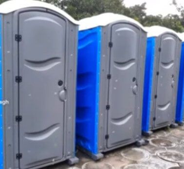 Row of blue and gray portable restrooms
